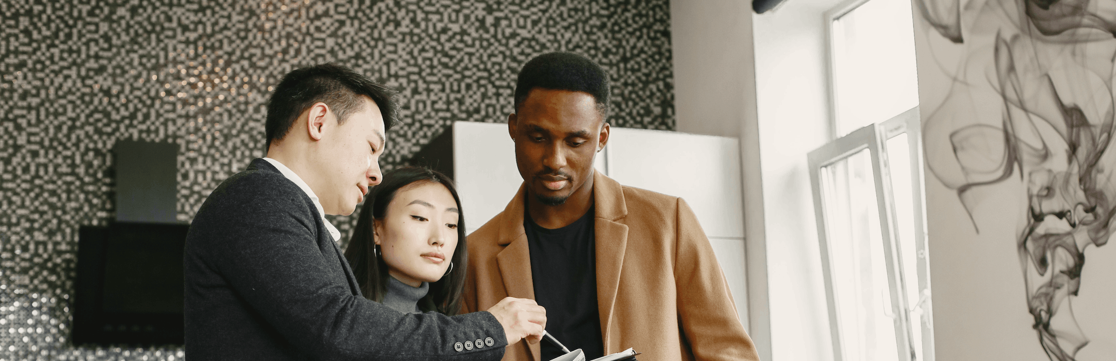 Mortgage broker reviewing renewal documents with a couple in their home